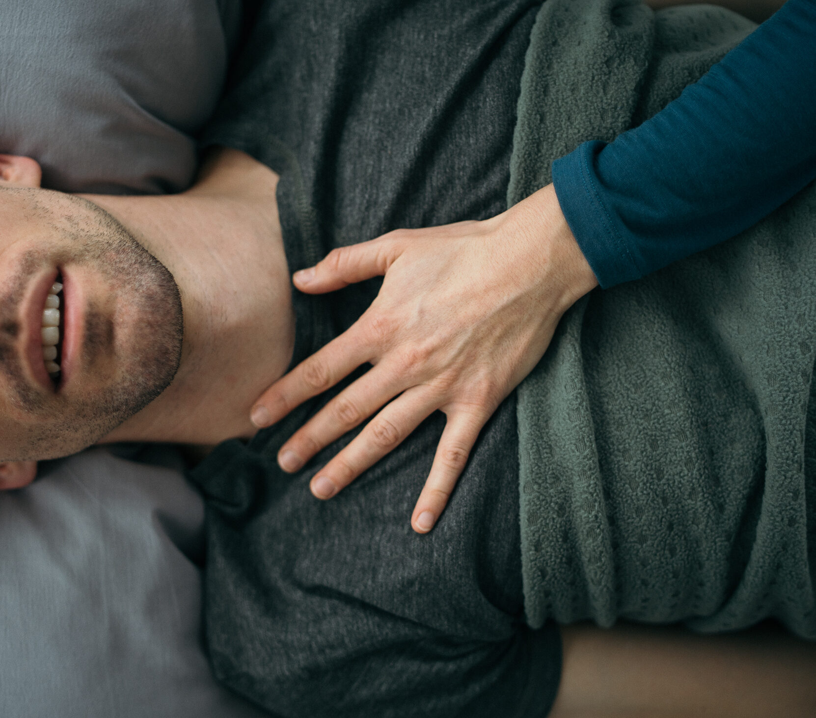 Picture of a hand on a mans chest.