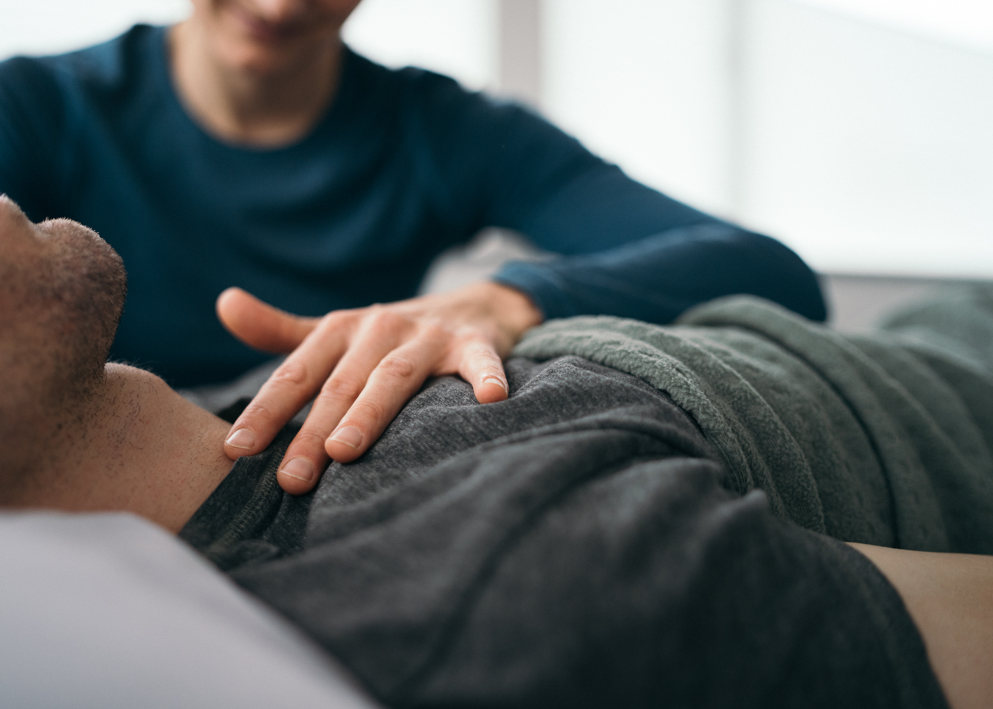 Picture of a hand laid on a man